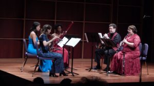 wind quintet players perform a concert 